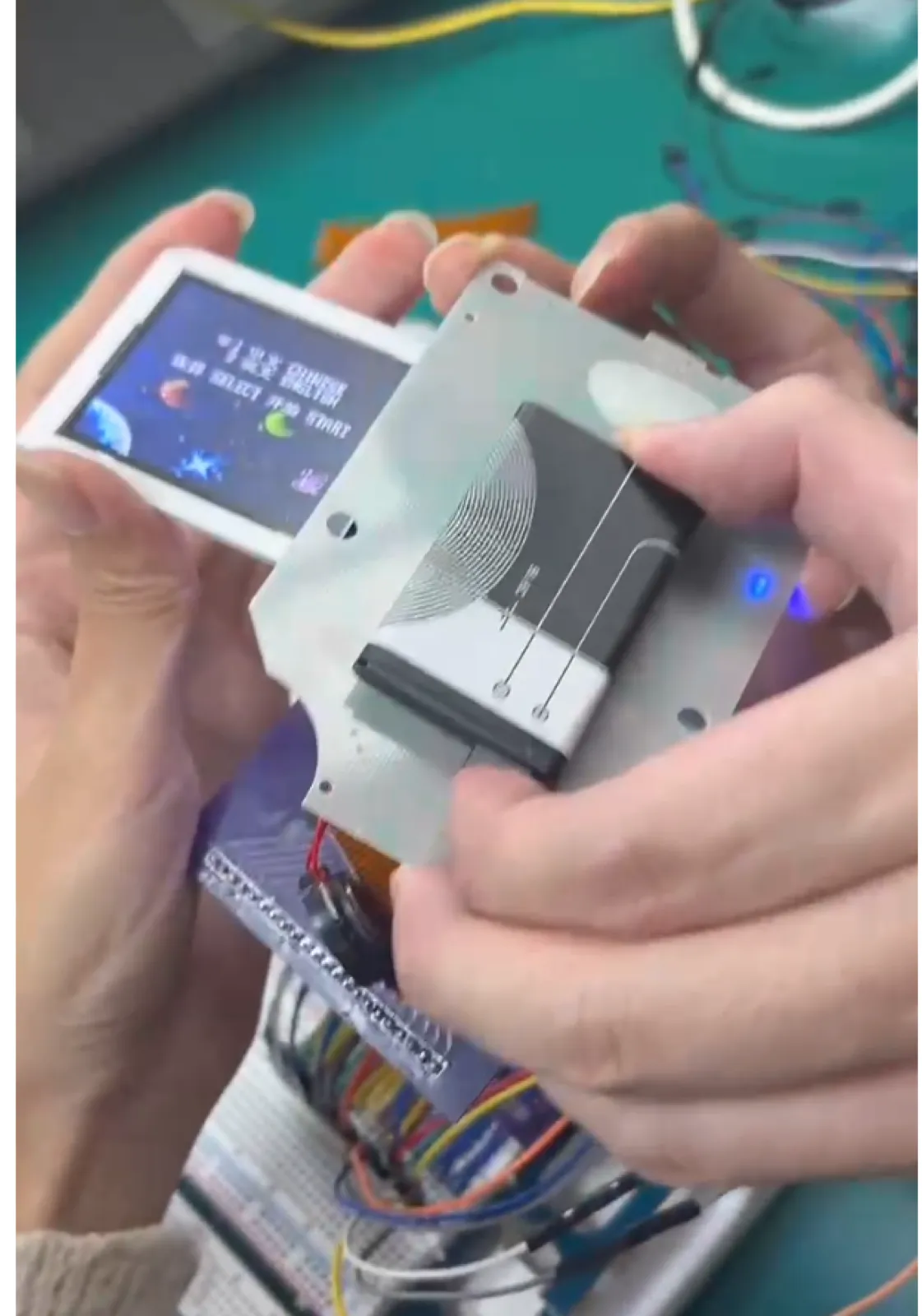 The chip is no longer on its original board — it sits on the adapter we drew ourselves, with signals routed back to the motherboard through that ribbon cable. Nothing counts until the screen lights up.